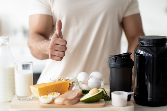 healthy food option male with thumbs up in kitchen