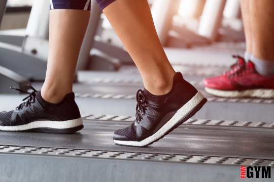 two people walking on treadmill