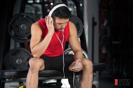 Male wearing headphone listening to energetic music whilst working out