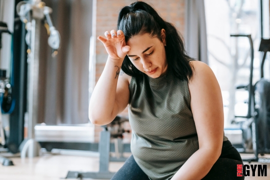 young girls in workout clothes with hand on her head