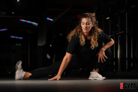 girl wearing black stretching in studio