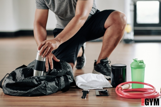male with gym bag and red band